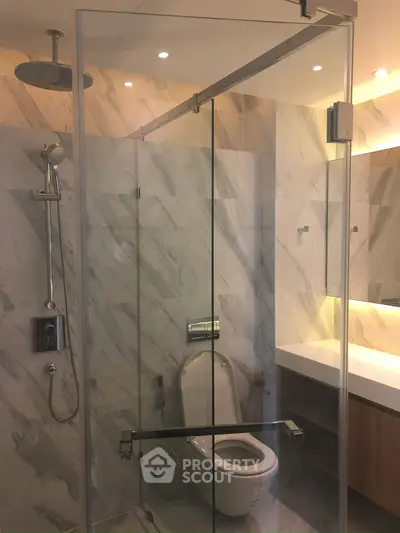 Luxurious modern bathroom with glass shower and elegant marble tiles