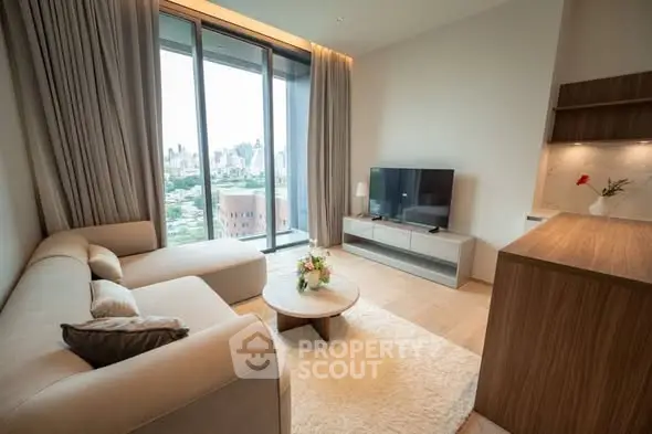 Modern living room with city view, cozy sofa, and stylish decor in a high-rise apartment.
