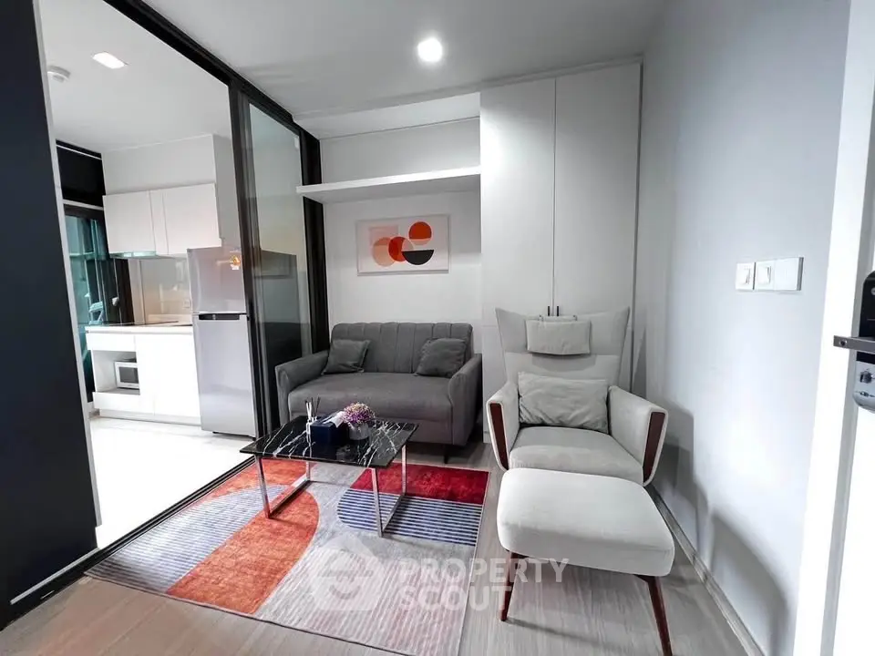 Modern living room with stylish furniture and open kitchen layout in a contemporary apartment.