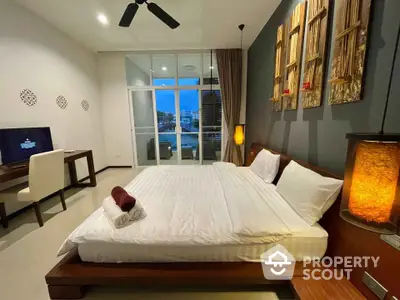 Spacious modern bedroom with elegant decor and large windows offering serene views.