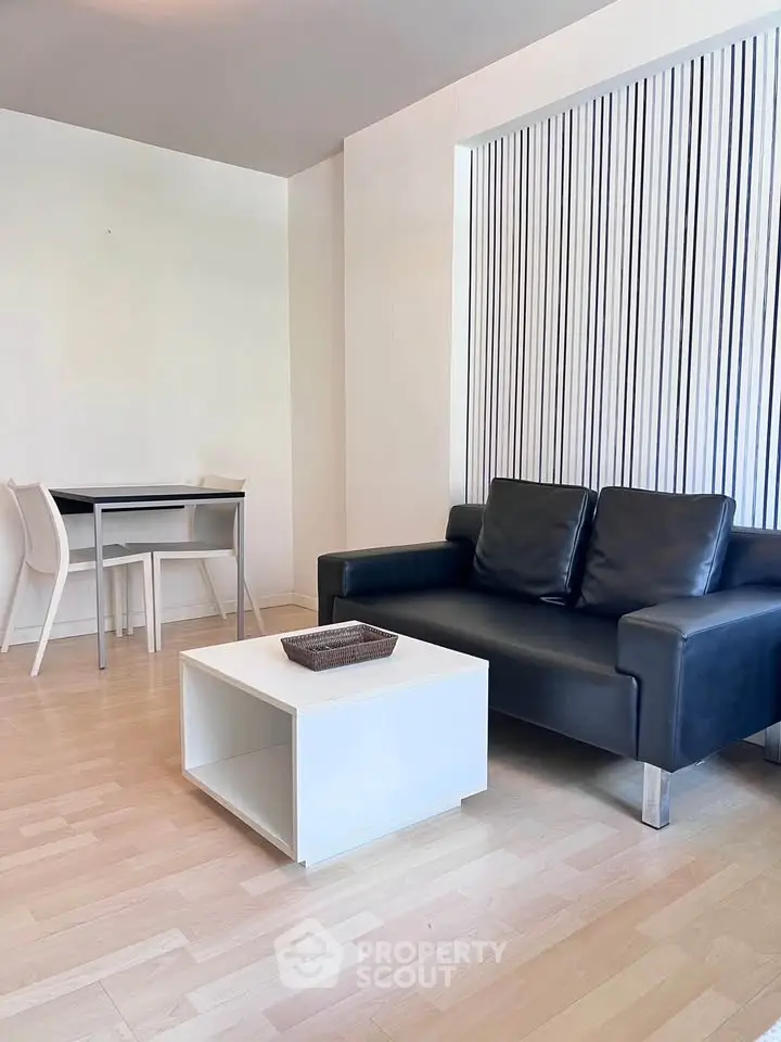 Modern living room with sleek black sofa and minimalist decor