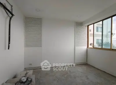 Spacious unfinished room with large windows and potential for customization