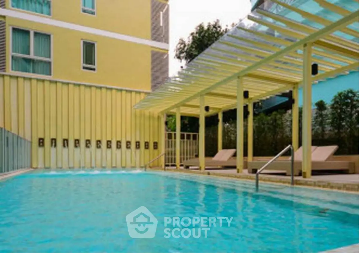 Luxurious apartment pool area with modern design and comfortable lounge chairs.