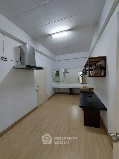Spacious interior with wooden flooring and modern fixtures, ideal for versatile use.