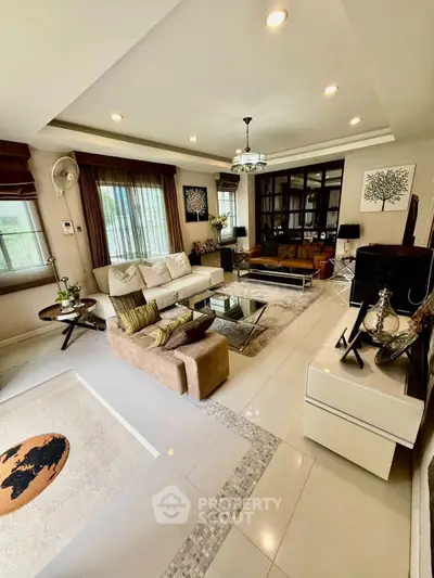 Spacious and elegant living room with modern decor and ample natural light.