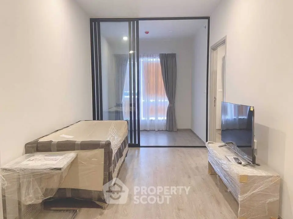 Modern studio apartment with glass partition and natural light