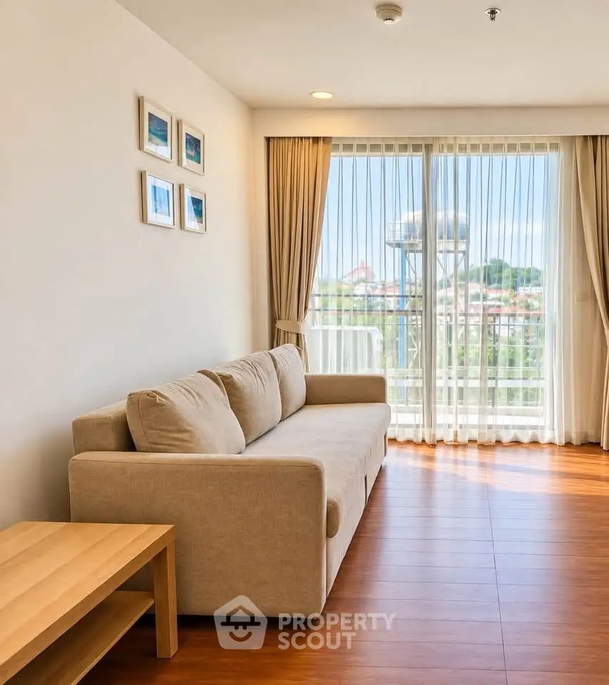 Bright living room with cozy sofa and large window offering scenic view