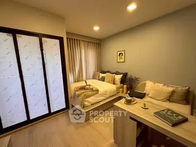 Cozy bedroom with modern decor and natural light, featuring a comfortable bed and stylish furnishings.