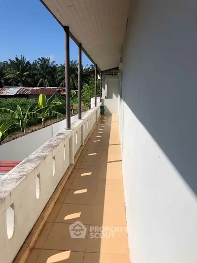 Charming outdoor corridor with scenic views of lush greenery, perfect for relaxation and enjoying nature.