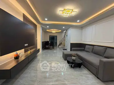 Spacious modern living room with elegant lighting and sleek furniture design.