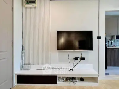 Modern living room with wall-mounted TV and sleek storage solutions