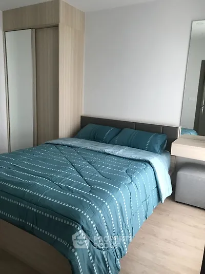 Cozy bedroom with modern decor and stylish bedding in a contemporary apartment.