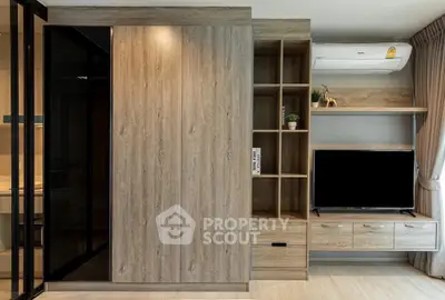 Modern living room with wooden cabinetry and sleek TV setup