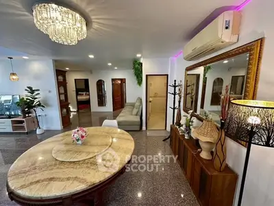 Spacious living room with elegant chandelier and stylish decor