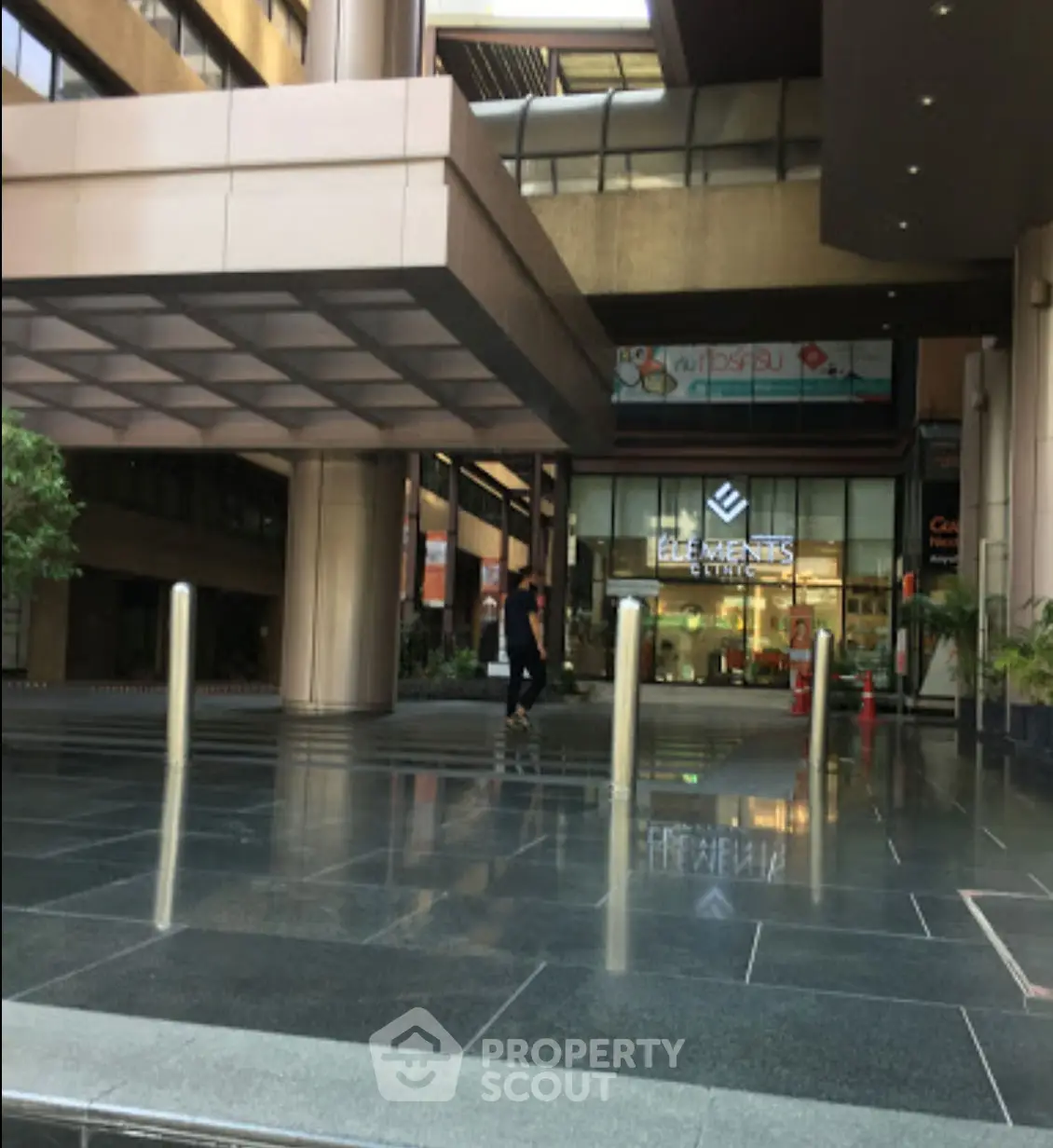 Modern building entrance with sleek design and reflective flooring