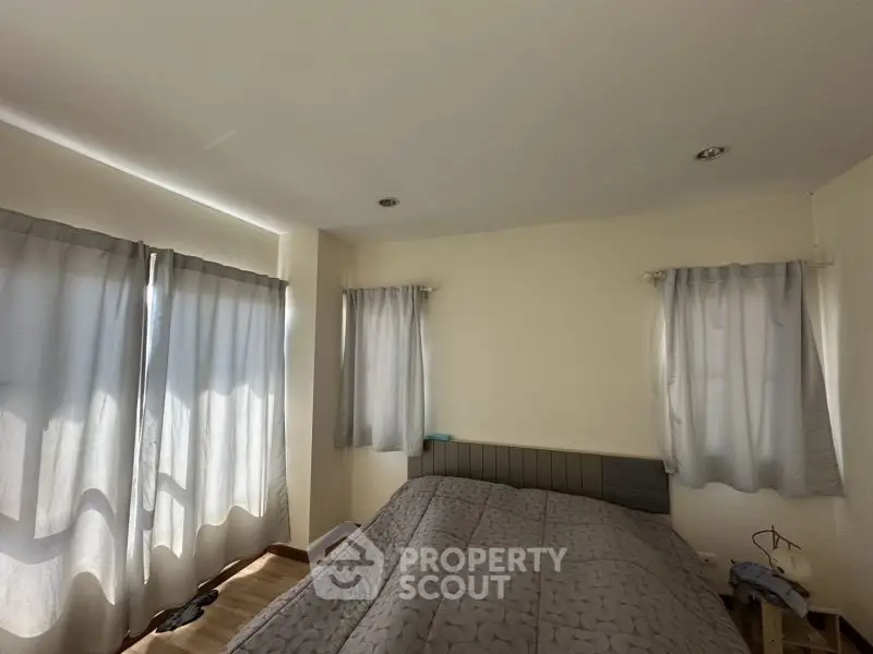 Cozy bedroom with soft lighting and modern decor, perfect for relaxation.