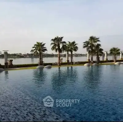 Luxurious waterfront pool with palm trees and serene lake view