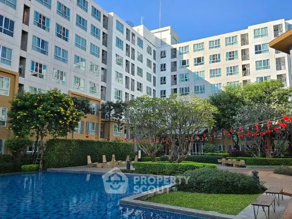 Modern apartment complex with pool and landscaped garden
