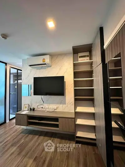 Modern living room with sleek TV setup and stylish wooden flooring