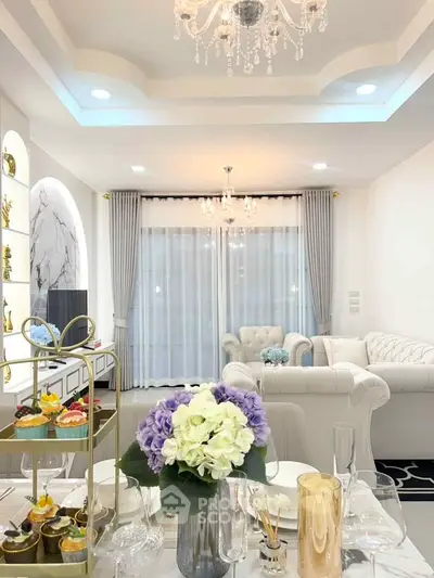 Luxurious living room with elegant decor, plush sofas, and a stunning chandelier, perfect for sophisticated living.