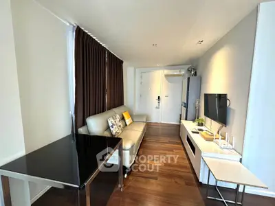 Modern living room with sleek furniture and wooden flooring in a stylish apartment.
