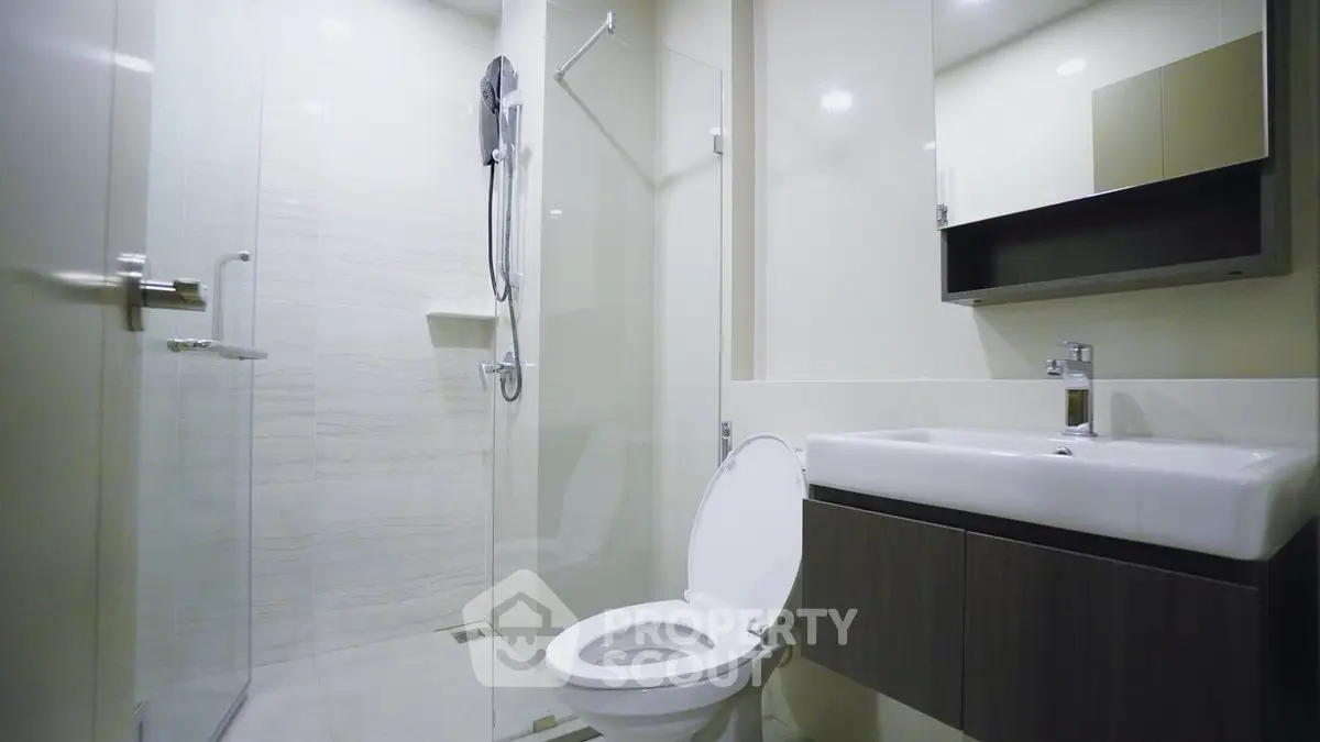 Modern bathroom with glass shower and sleek fixtures