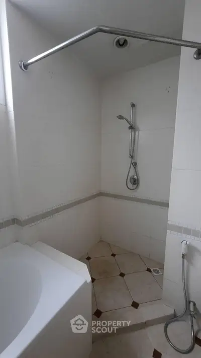 Spacious bathroom with modern shower and bathtub