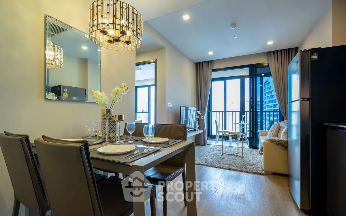 Modern open-plan living and dining area with balcony view in a stylish apartment.