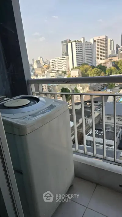 City view from a balcony with washing machine, ideal for urban living.