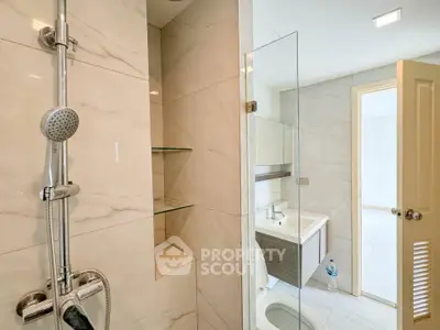 Modern bathroom with glass shower and sleek fixtures in a contemporary home.