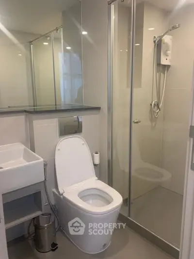 Modern bathroom with sleek fixtures and glass shower enclosure