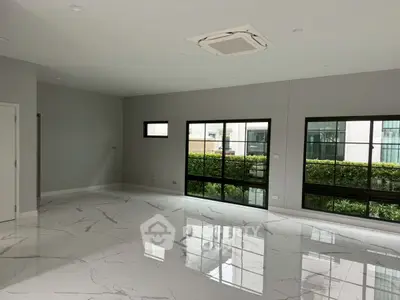 Spacious modern living room with marble flooring and large windows