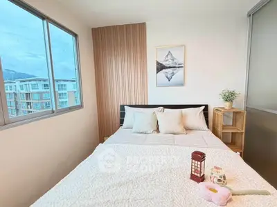 Cozy bedroom with large windows offering a scenic view, featuring a comfortable bed and stylish decor.