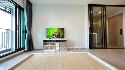 Modern living room with sliding glass doors and balcony view