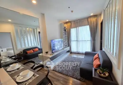 Modern living room with stylish decor and large window for natural light.