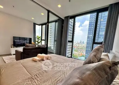 Luxurious bedroom with stunning city view and modern decor in high-rise apartment.