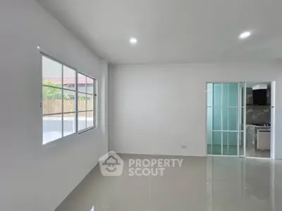 Spacious modern living room with large windows and sliding glass doors