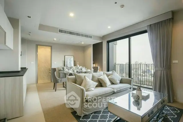 Modern living room with elegant decor and city view balcony in luxury apartment.