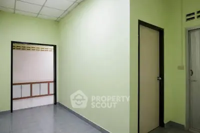 Spacious interior with light green walls and tiled flooring, ideal for customization.