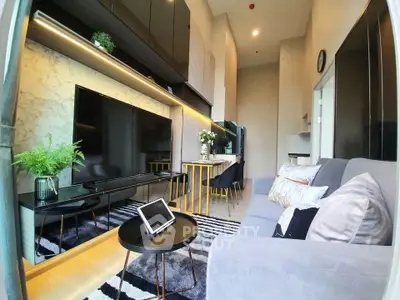 Modern living room with sleek design, large TV, and stylish decor in a contemporary apartment.