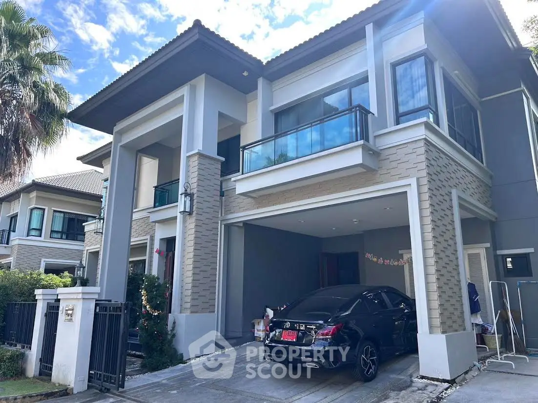 Modern two-story house with sleek design and spacious driveway in a serene neighborhood.