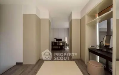 Spacious modern bedroom with elegant decor and ample natural light.