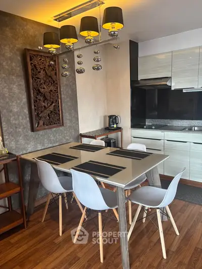 Modern kitchen with stylish dining area and contemporary lighting