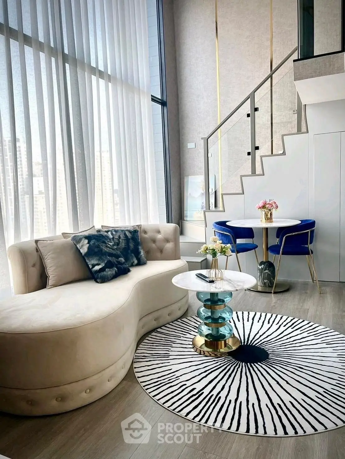 Luxurious modern living room with stylish furniture and large windows