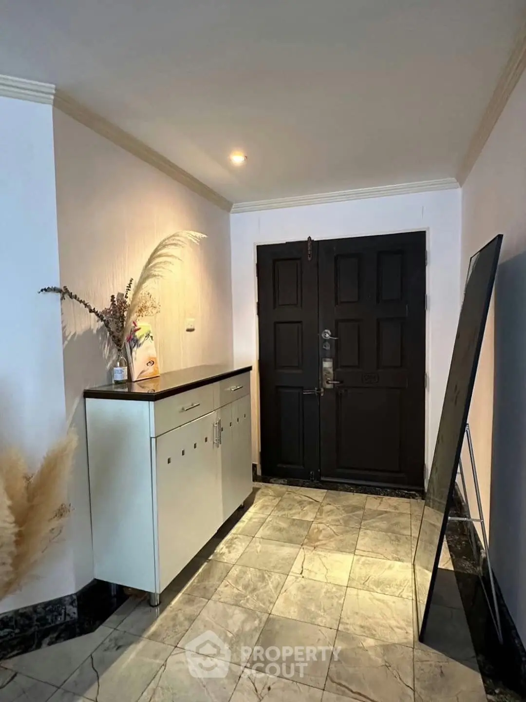 Chic entryway with stylish decor and elegant double doors, perfect for a welcoming home ambiance.