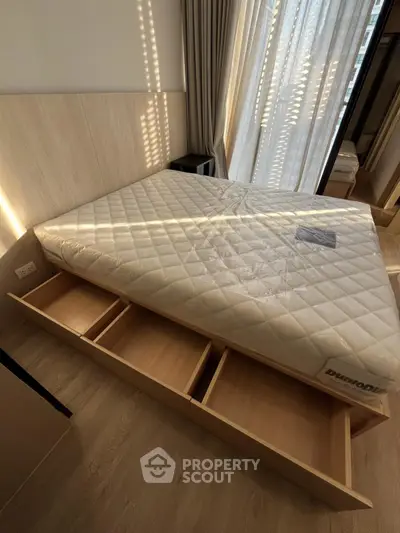 Modern bedroom with built-in storage bed and natural light