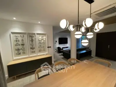 Modern living room with stylish lighting and elegant dining area