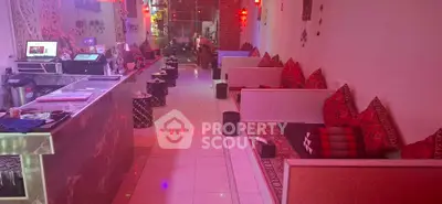 Cozy lounge area with vibrant red decor and modern seating arrangement