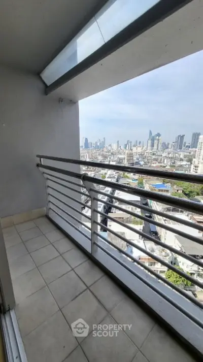 Stunning city view from a high-rise balcony with modern railing and tiled floor.