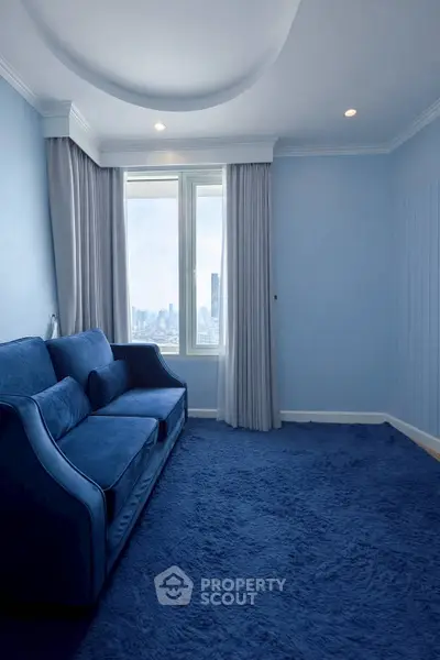 Elegant blue living room with plush carpet and city view window